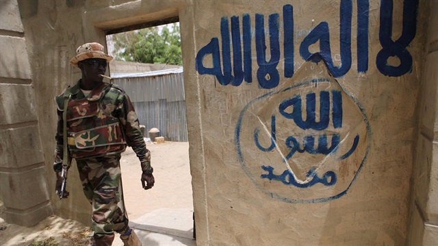 File photo: A Nigerien soldier walks out of a house that residents say a Boko Haram militant had forcefully seized and occupied in Damasak 