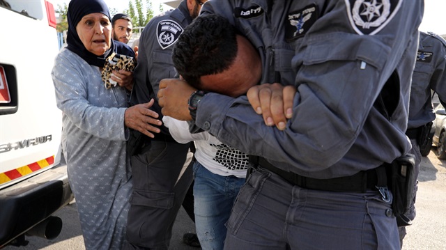 Israeli police detain a Palestinian family