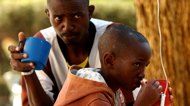 Patients await treatment at a makeshift cholera clinic