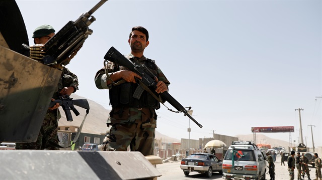 Afghan National Army (ANA) soldiers keep watch at a checkpoint 