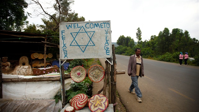 File photo: A man walks near a sign in Falasha, a Jewish village on the outskirts of Ethiopia's city of Gondar
