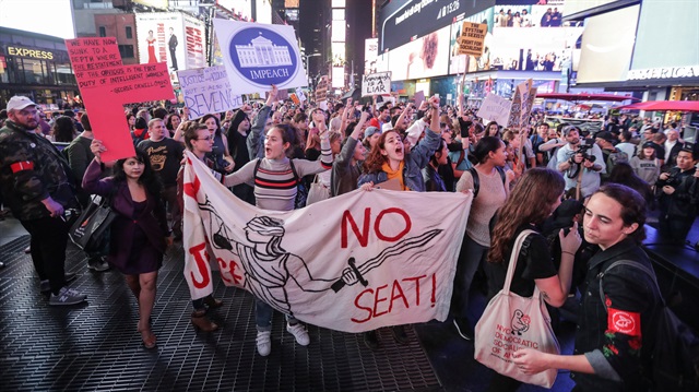 Activists march in opposition to U.S. Supreme Court nominee Brett Kavanaugh and in support for Christine Blasey Ford, the university professor who has accused Kavanaugh of sexual assault in 1982, in Times Square in New York City, New York, U.S., October 6, 2018.