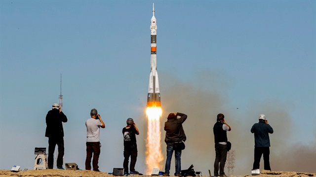 Photographers take pictures as the Soyuz MS-10 spacecraft carrying the crew of astronaut Nick Hague of the U.S. and cosmonaut Alexey Ovchinin of Russia blasts off to the International Space Station (ISS) from the launchpad at the Baikonur Cosmodrome, Kazakhstan October 11, 2018. 