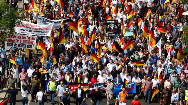 Supporters of the Anti-immigration party Alternative for Germany (AfD) hold German flags during a protest in Berlin, Germany, May 27, 2018