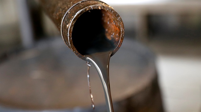 Oil pours out of a spout.