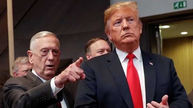File photo: U.S. President Donald Trump walks in with U.S. Defense Secretary Jim Mattis