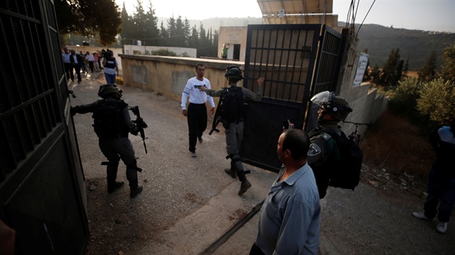 Israeli forces close the gate of a Palestinian school near Nablus in the occupied West Bank 