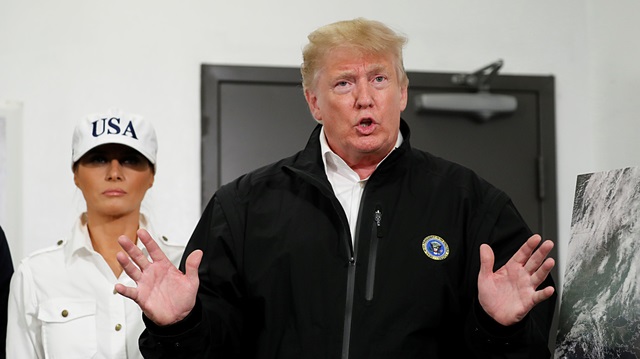 U.S. President Donald Trump speaks to reporters with first lady Melania Trump