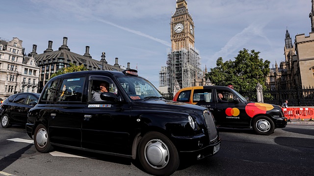 File photo: Black taxis pass the Houses of Parliament in London, Britain 