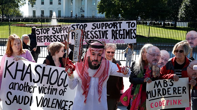 An activist dressed as Saudi Crown Prince Mohammad bin Salman holds a prop bonesaw during a demonstration calling for sanctions against Saudi Arabia and to protest the disappearance of Saudi journalist Jamal Khashoggi, outside the White House in Washington, U.S., October 19, 2018.  