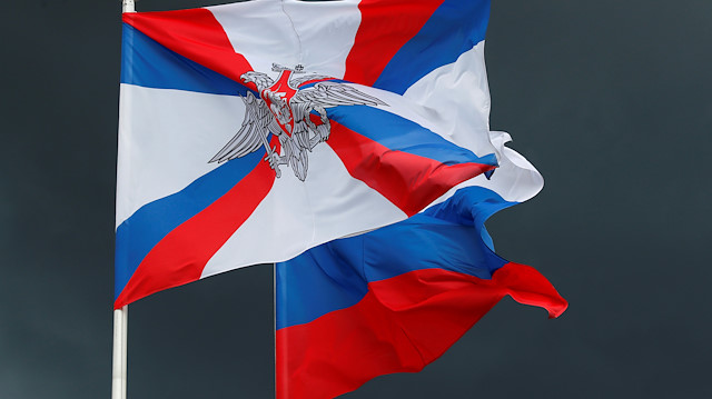 File photo:  The flag of Russia's Defence Ministry and the Russian state flag 