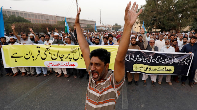 A supporter of religious and political party Jamaat-e-Islami (JI) chants slogans with others after the Supreme Court overturned the conviction of a Christian woman sentenced to death for blasphemy against Islam, during a protest in Karachi, Pakistan October 31, 2018. The writing on the banners reads in Urdu, "Ready to sacrifice our life for Mohammad; "No insult will be accepted on the sanctity of Mohammad".
