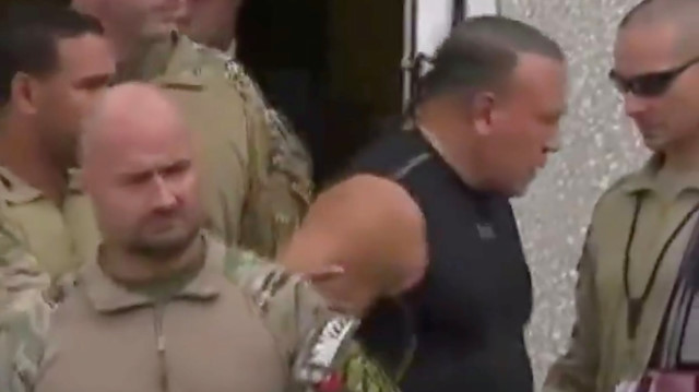 Cesar Altieri Sayoc, who was arrested during an investigation into a series of parcel bombs, is escorted from an FBI facility in Miramar, Florida October 26, 2018 in a still image from video.
