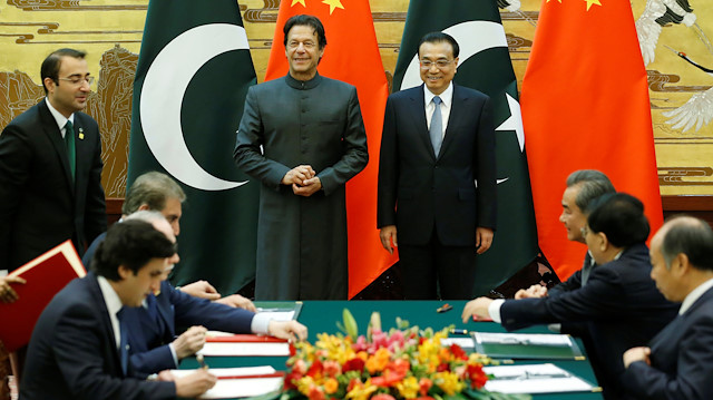 Pakistani Prime Minister Imran Khan (centre L) and China's Premier Li Keqiang attend a signing ceremony at the Great Hall of the People in Beijing, China, November 3, 2018. 