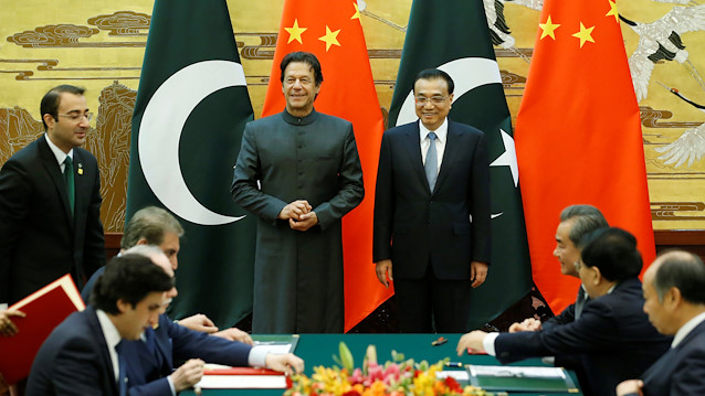 Pakistani Prime Minister Imran Khan (centre L) and China's Premier Li Keqiang attend a signing ceremony at the Great Hall of the People in Beijing, China, November 3, 2018