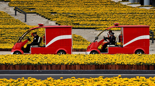 Firemen drive electric firetrucks at the National Exhibition and Convention Center, the venue for the upcoming China International Import Expo (CIIE), in Shanghai, China.