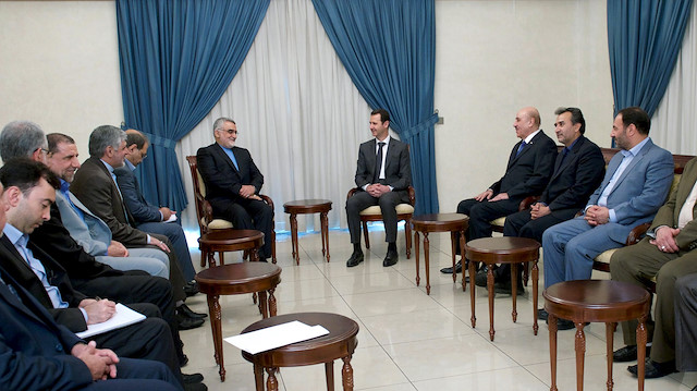 Syria's President Bashar al-Assad (C-R) meets with Alaeddin Boroujerdi (C-L), Chairman of Iranian Parliament's National Security and Foreign Policy Commission, in the presence of Ali Mamlouk (5th R), head of Syria's national security office in Damascus, in this handout provided by SANA on May 13, 2015. 