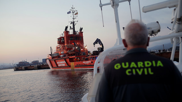 A sergeant of the Spanish Civil Guard navigates a boat next to The "Maria Zambrano" rescue vessel with migrants, intercepted aboard a toy dinghy off the coast in the Strait of Gibraltar, after arriving at the port of the new Center for Temporary Assistance to Foreigners (CATE) in San Roque, near Algeciras, southern Spain August 10, 2018. 