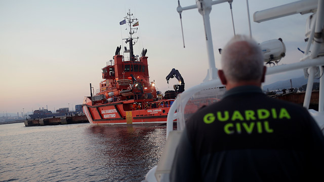 A sergeant of the Spanish Civil Guard navigates a boat next to The "Maria Zambrano" rescue vessel with migrants, intercepted aboard a toy dinghy off the coast in the Strait of Gibraltar, after arriving at the port of the new Center for Temporary Assistance to Foreigners (CATE) in San Roque, near Algeciras, southern Spain August 10, 2018.