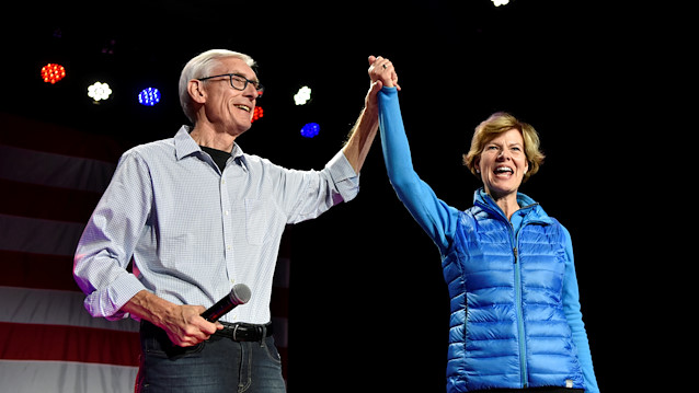 Democratic gubernatorial candidate Tony Evers (L) and U.S. Senator Tammy Baldwin (D-WI) react to supporters at an election eve rally in Madison, Wisconsin, U.S. November 5, 2018. 