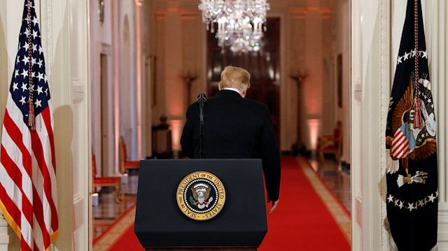 U.S. President Donald Trump departs a news conference 