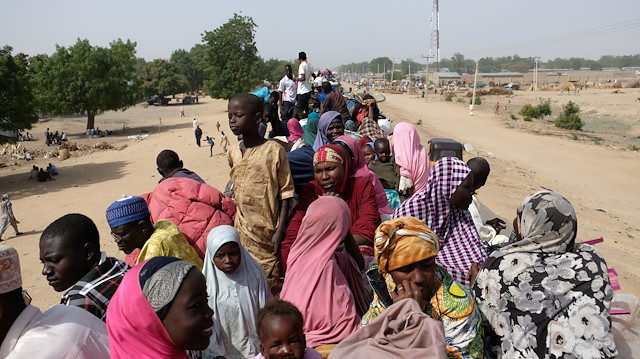 Refugees wait on top of a truck in the Muna Garage area in the northeastern Nigerian city of Maiduguri, Nigeria 