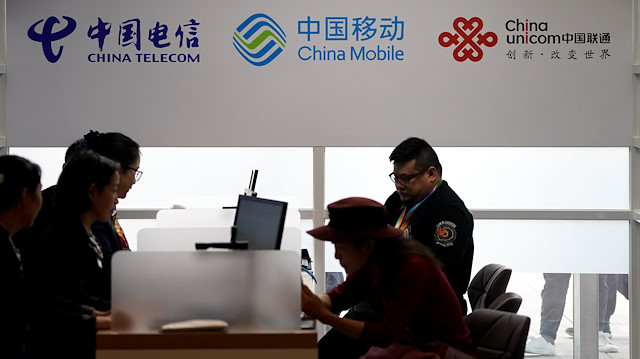 Signs of China Telecom and China Mobile and China Unicom are seen during the China International Import Expo (CIIE), at the National Exhibition and Convention Center in Shanghai, China November 5, 2018. 