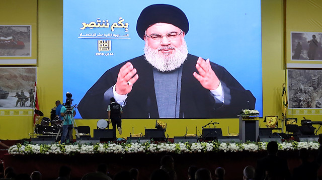Lebanon's Hezbollah leader Sayyed Hassan Nasrallah gestures as he addresses his supporters via a screen in Beirut, Lebanon August 14, 2018. 