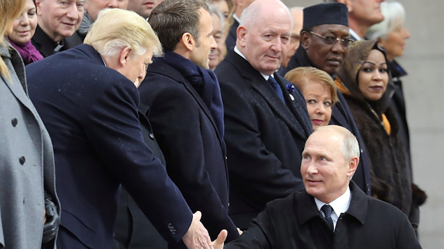 Russian President Vladimir Putin shakes hands with U.S. President Donald Trump