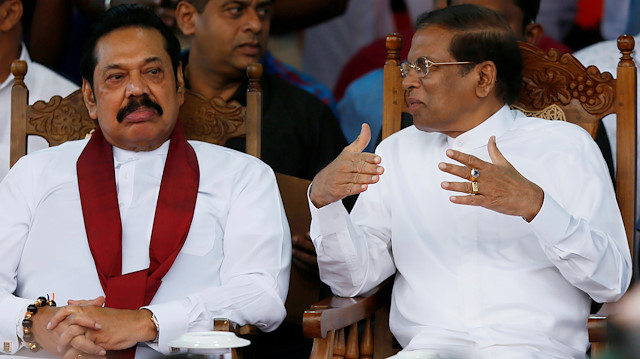 Sri Lanka's newly appointed Prime Minister Mahinda Rajapaksa and President Maithripala Sirisena talk during a rally near the parliament in Colombo, Sri Lanka.