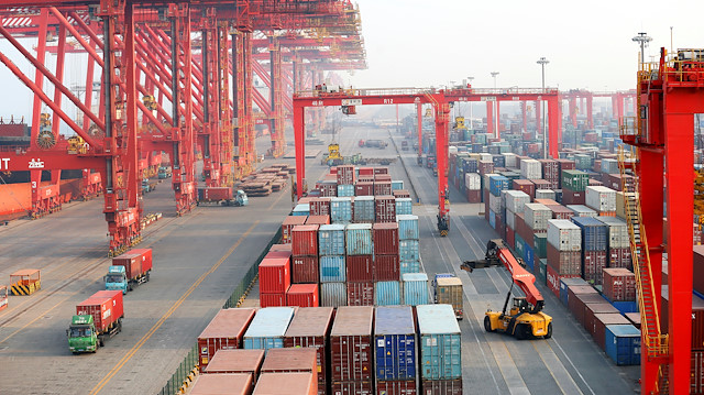 Containers and trucks are seen on the dock at Rizhao Port in Rizhao, Shandong province, China.