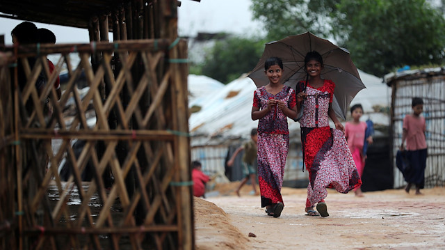 Rohingya refugee girls walk along the Kutupalong camp in Cox's Bazar, Bangladesh