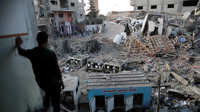 A Palestinian man looks at the remains of Hamas's TV station building