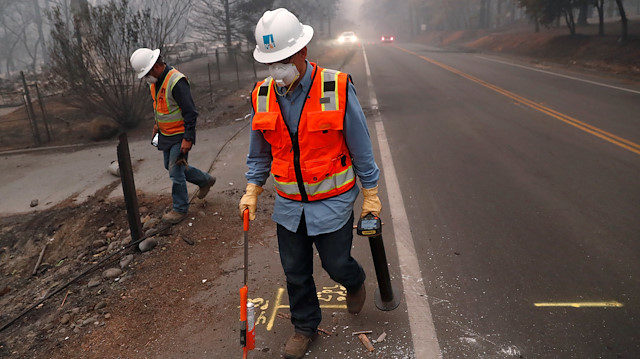 Employees of Pacific Gas & Electric (PG&E) mark gas lines in the aftermath of the Camp Fire in Paradise, California, U.S., November 14, 2018. 