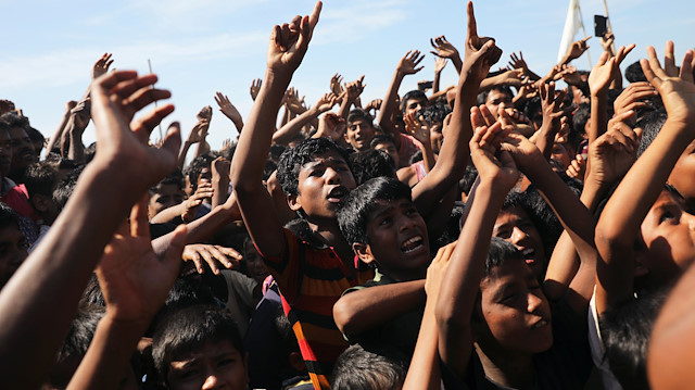 Hundreds of Rohingya refugees shout slogans as they protest against their repatriation