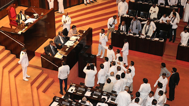 Sri Lanka's parliament members argue in front of Speaker of the Parliament Karu Jayasuriya during the parliament session in Colombo, Sri Lanka November 14, 2018. 
