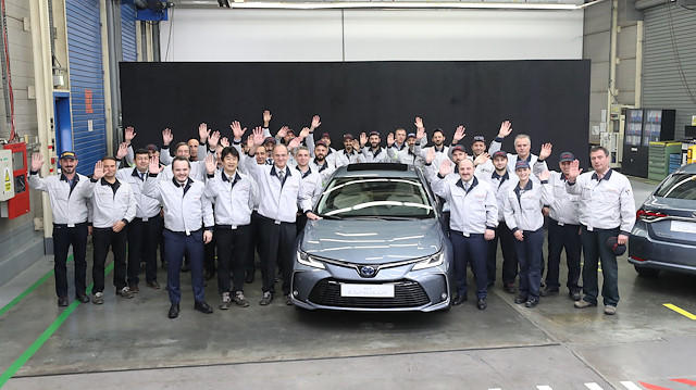 Turkish Technology and Industry Minister Mustafa Varank poses next to Toyota Corolla Hybrid model