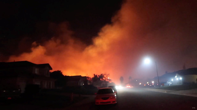 Sierra Fire approaches homes in Rialto, California, U.S. November 13, 2018 in this still image obtained from a social media video on November 14, 2018. 