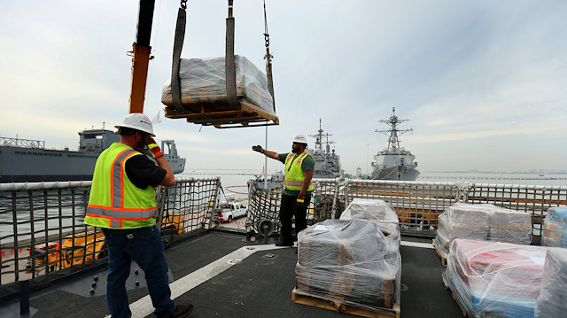 Workers unload some the 39,000 pounds of seized cocaine off the U.S. Coast Guard Cutter 