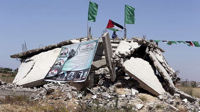 A Palestinian boy sits on top of the ruins of a house that witnesses said was destroyed by Israeli shelling 
