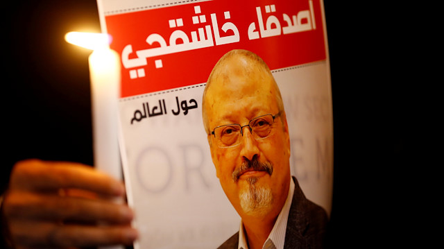 A demonstrator holds a poster with a picture of Saudi journalist Jamal Khashoggi