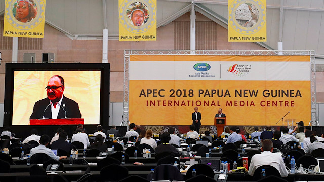 Papua New Guinea Prime Minister Peter O'Neill speaks as the Asia Pacific Economic Cooperation (APEC) Chief Executive Officer, Chris Hawkins listens during a media conference at the end of the APEC forum in Port Moresby, Papua New Guinea, November 18, 2018. 