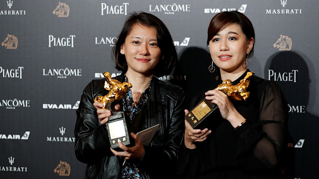Taiwan's director Yue Fu (R) poses backstage after winning Best Documentary for her movie "Our Youth in Taiwan" at the 55th Golden Horse Awards in Taipei, Taiwan.