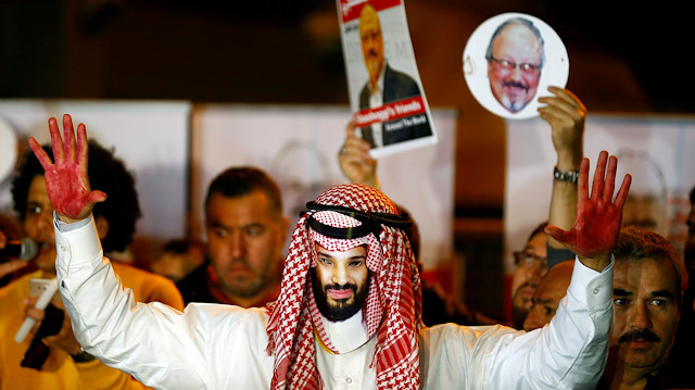 A demonstrator wearing a mask of Saudi Crown Prince Mohammed bin Salman