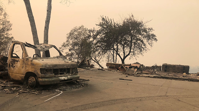 The wreckage of a vehicle is seen along the road in the aftermath of wildfires in Paradise, California, U.S., November 12, 2018. 