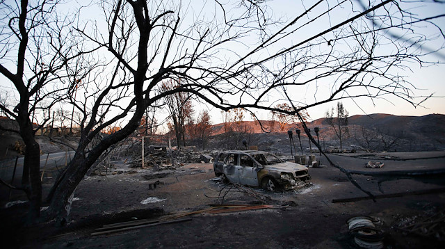 The burnt wreckage of a vehicle and debris are seen in the aftermath of the Woolsey fire in Malibu, Southern California, U.S. November 11, 2018. 