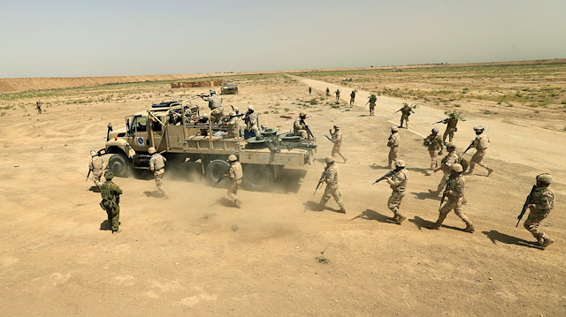 Iraqi Army's 53rd Brigade participate in a live ammunition training exercise with coalition forces trainers at Taji military base north of Baghdad, Iraq August 9, 2017.