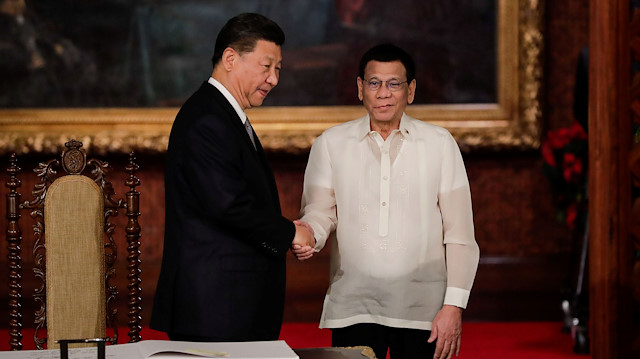 China's President Xi Jinping and Philippine President Rodrigo Duterte shake hands after a book signing at the Malacanang presidential palace in Manila, Philippines, November 20, 2018.