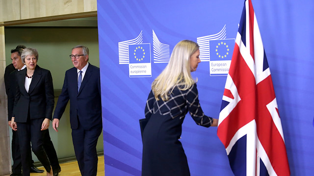 A staff member adjusts the British flag