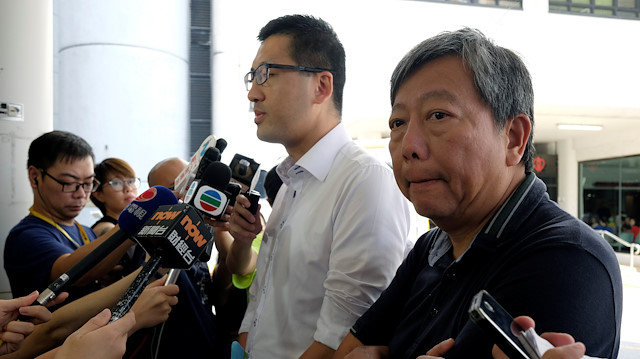Pro-democracy lawmaker Lam Cheuk-ting (L) and Democratic Party member Lee Cheuk-yan meet journalists outside a hospital in Hong Kong, China.